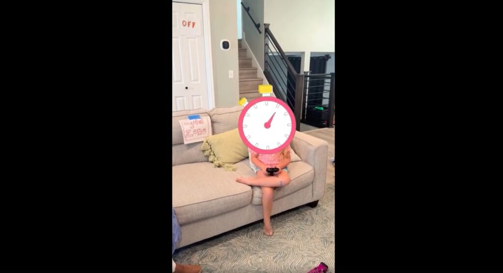 girl sitting on couch with a graphic of a stopwatch covering her face